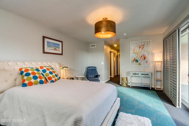 bedroom featuring dark colored carpet