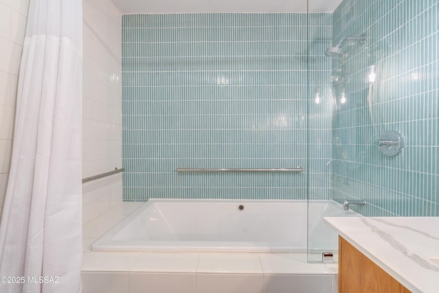 bathroom with vanity, shower / bathtub combination with curtain, and tile walls