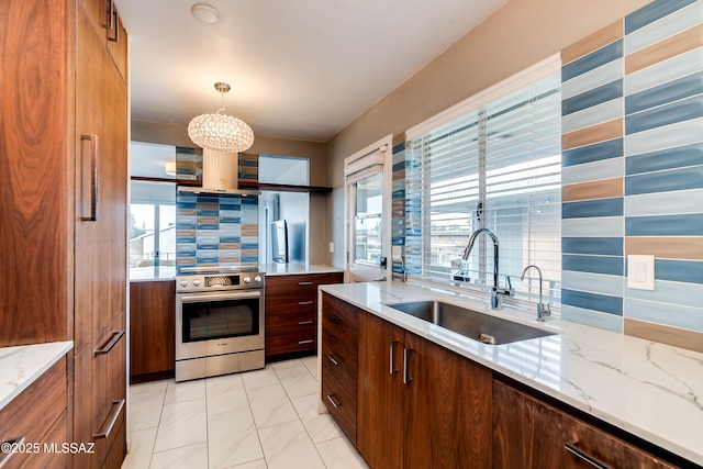 kitchen featuring sink, hanging light fixtures, electric range, tasteful backsplash, and light stone counters