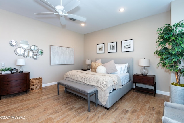 bedroom with ceiling fan and light hardwood / wood-style floors