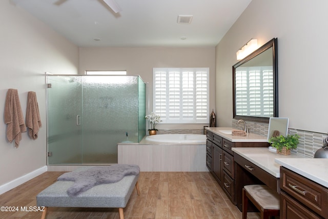 bathroom featuring hardwood / wood-style floors, vanity, and independent shower and bath