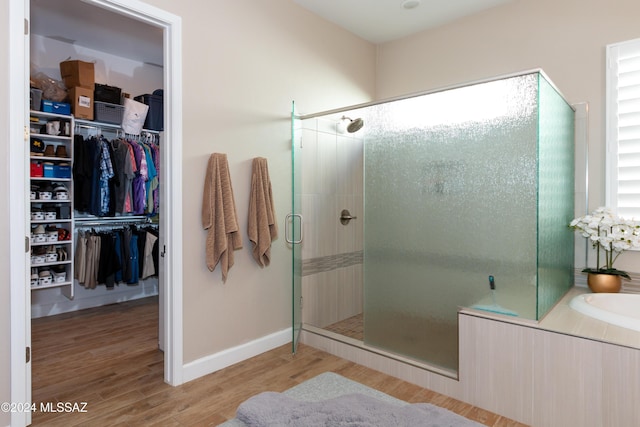 bathroom featuring wood-type flooring and walk in shower