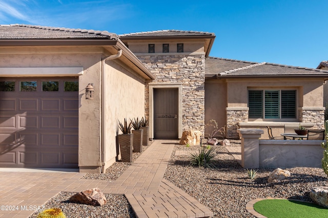 doorway to property with a garage