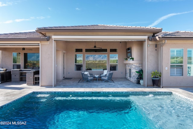 view of pool with outdoor lounge area, ceiling fan, and a patio