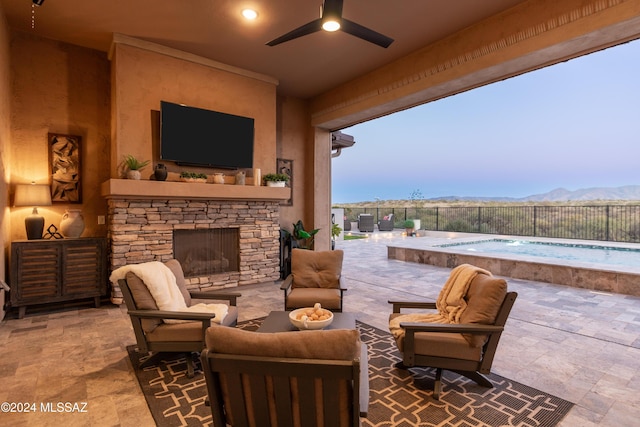 view of patio with an outdoor living space with a fireplace, ceiling fan, and a fenced in pool