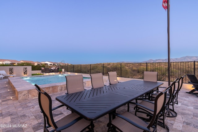 view of patio featuring a mountain view, pool water feature, and a fenced in pool