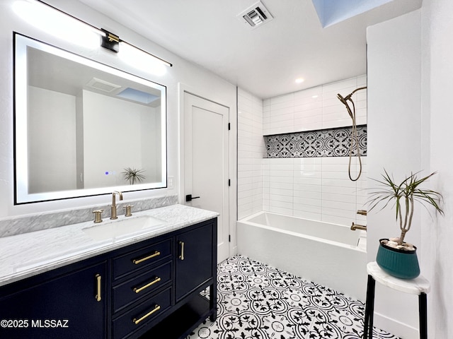 bathroom with tile patterned floors, visible vents, tub / shower combination, and vanity