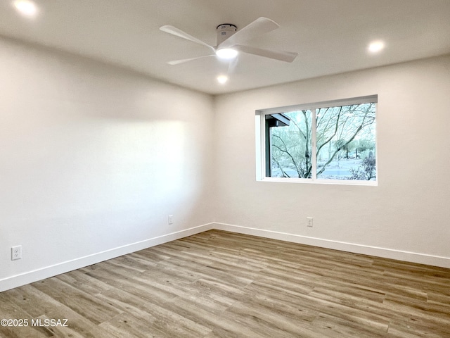 empty room with a ceiling fan, recessed lighting, baseboards, and wood finished floors