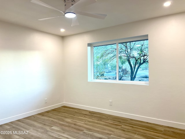 unfurnished room with a ceiling fan, recessed lighting, baseboards, and wood finished floors