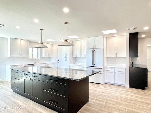 kitchen featuring light wood-style floors, visible vents, white cabinets, and high end white fridge