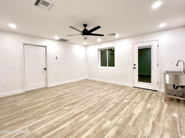 unfurnished living room featuring light wood-style flooring, visible vents, and recessed lighting