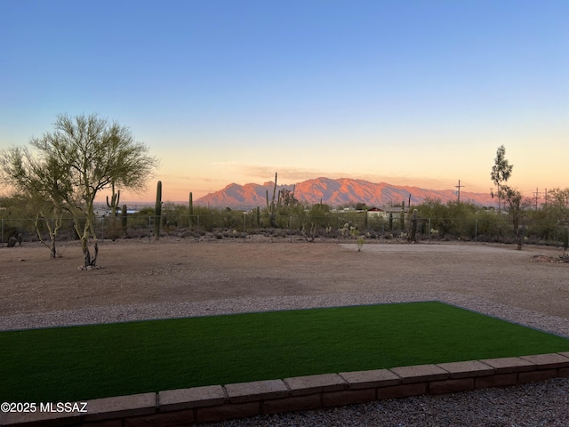 view of community with a lawn and a mountain view