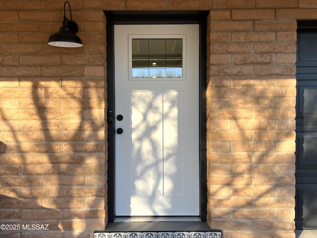 property entrance with brick siding