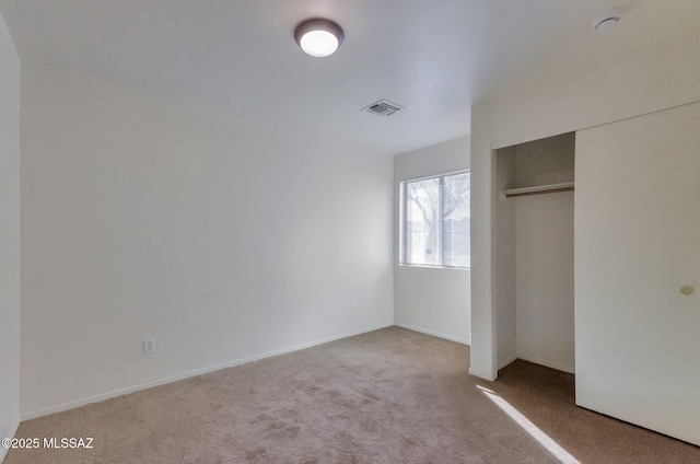 unfurnished bedroom featuring a closet and carpet floors