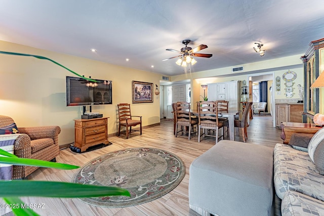 living room with ceiling fan and light hardwood / wood-style floors