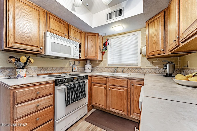 kitchen with ceiling fan, white appliances, and sink