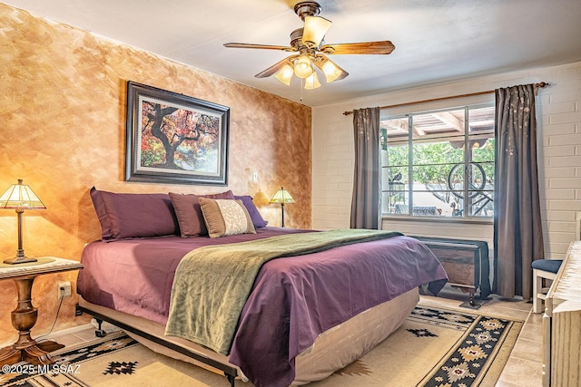 tiled bedroom featuring ceiling fan