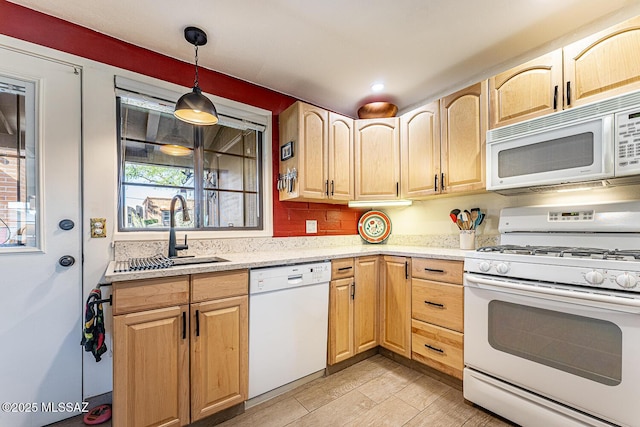 kitchen with light brown cabinetry, white appliances, decorative light fixtures, and sink