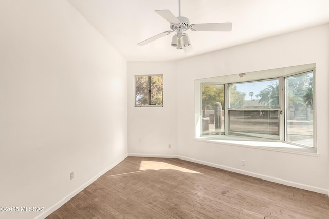 empty room with ceiling fan and light wood-type flooring