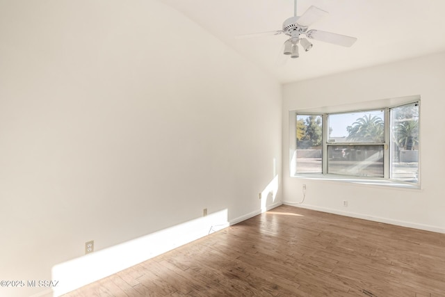 empty room featuring vaulted ceiling, ceiling fan, and wood-type flooring