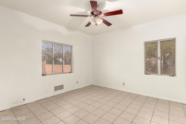 tiled empty room with ceiling fan