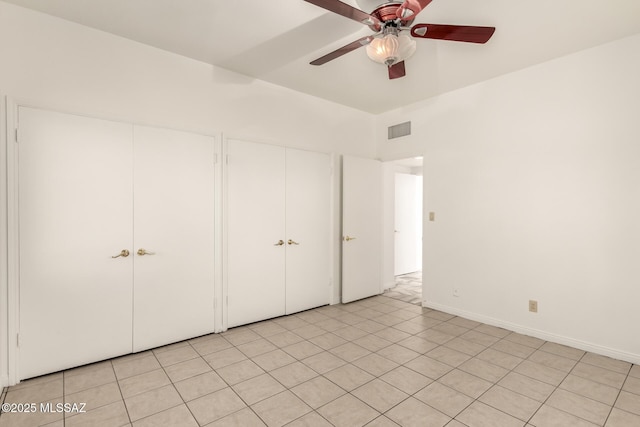 unfurnished bedroom with ceiling fan and light tile patterned floors