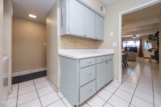 kitchen featuring light tile patterned flooring, ceiling fan, and tasteful backsplash