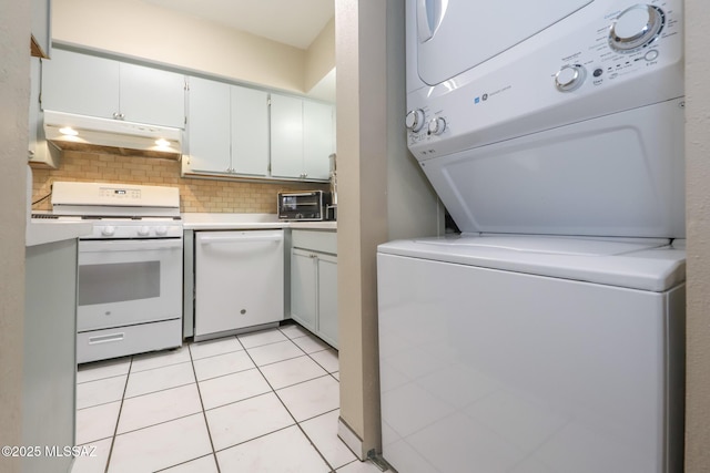 washroom with stacked washing maching and dryer and light tile patterned floors