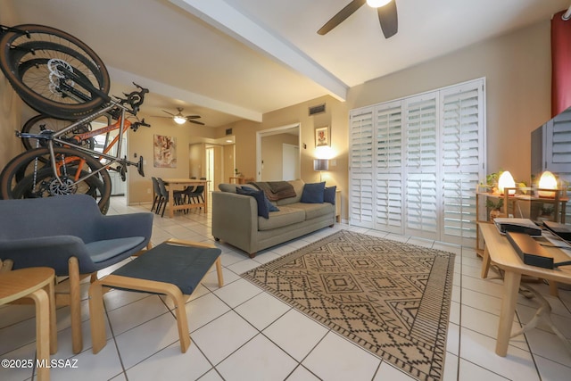 tiled living room featuring beamed ceiling and ceiling fan