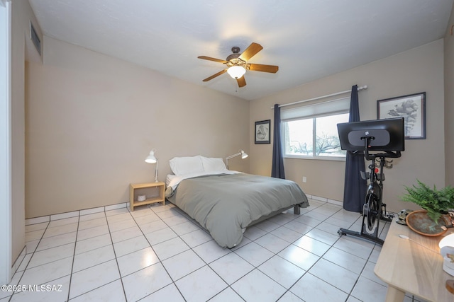 bedroom with ceiling fan and light tile patterned floors