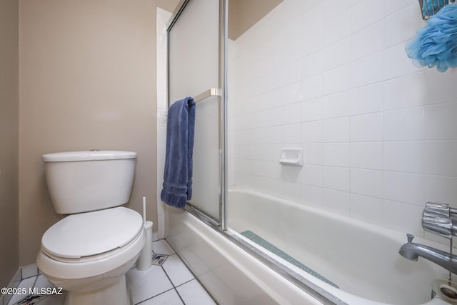 bathroom with tile patterned flooring, bath / shower combo with glass door, and toilet