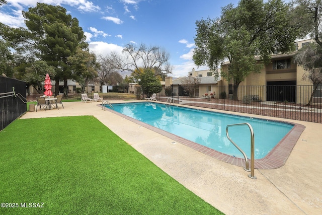 view of pool featuring a yard and a patio area