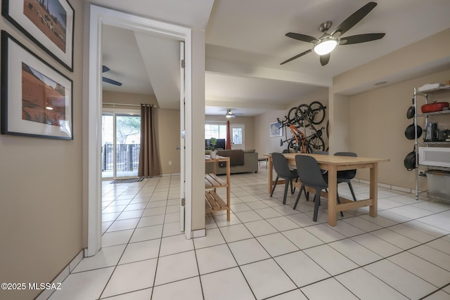 dining area featuring light tile patterned flooring, ceiling fan, and plenty of natural light