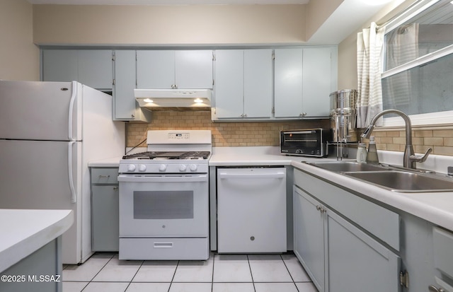 kitchen featuring light tile patterned flooring, sink, backsplash, and white appliances