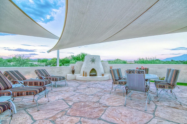 view of patio featuring an outdoor fireplace and outdoor dining area