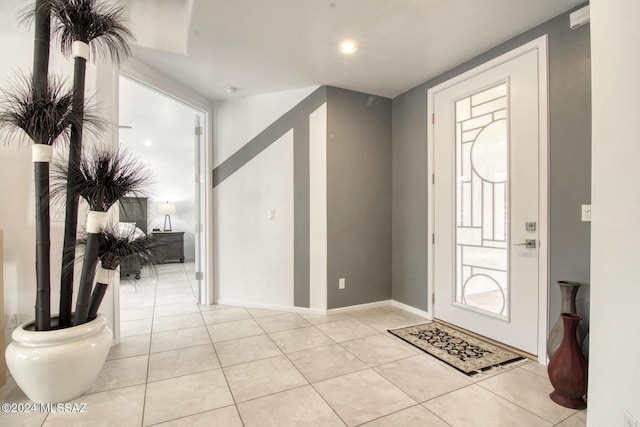 entryway featuring light tile patterned flooring and baseboards