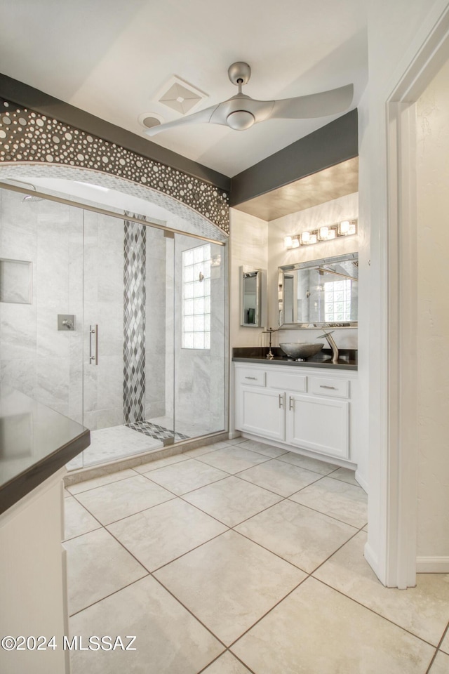 bathroom with a stall shower, vanity, and tile patterned floors