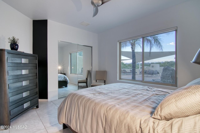 bedroom with visible vents, baseboards, ceiling fan, a closet, and light tile patterned flooring