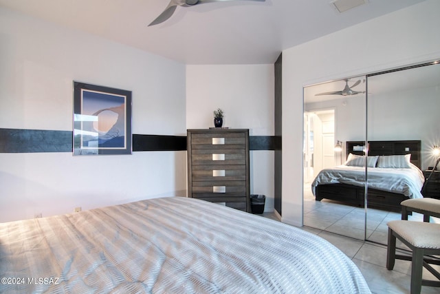 tiled bedroom with a closet, visible vents, and ceiling fan