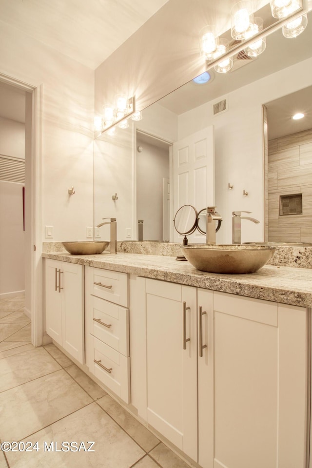 full bath featuring double vanity, visible vents, and a sink