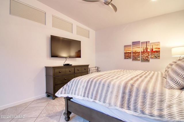 bedroom featuring a ceiling fan, baseboards, and light tile patterned floors