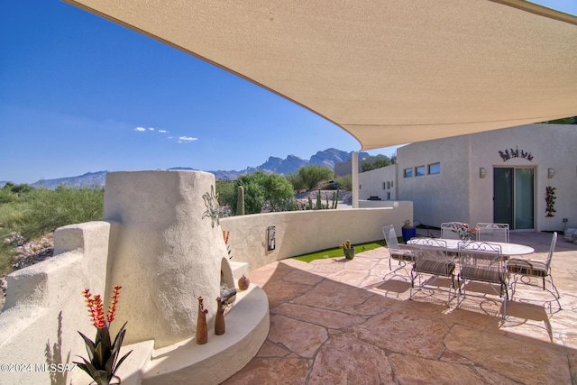 view of patio with a mountain view and outdoor dining space