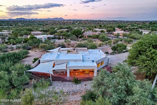 aerial view at dusk featuring a mountain view