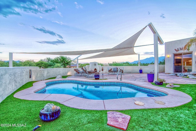 view of swimming pool with a fenced in pool, a patio area, fence, and a lawn