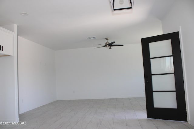 spare room featuring visible vents and a ceiling fan
