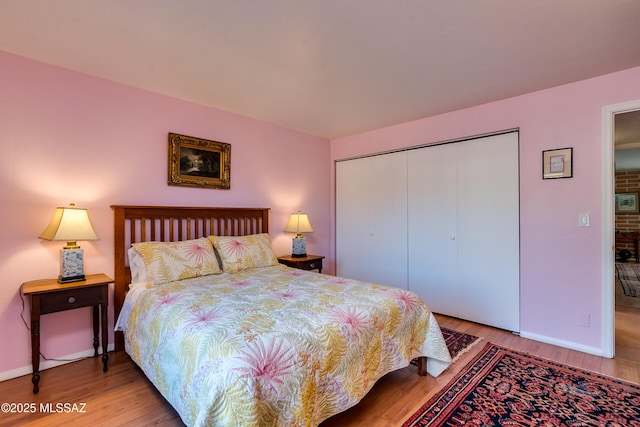 bedroom with a closet and hardwood / wood-style floors