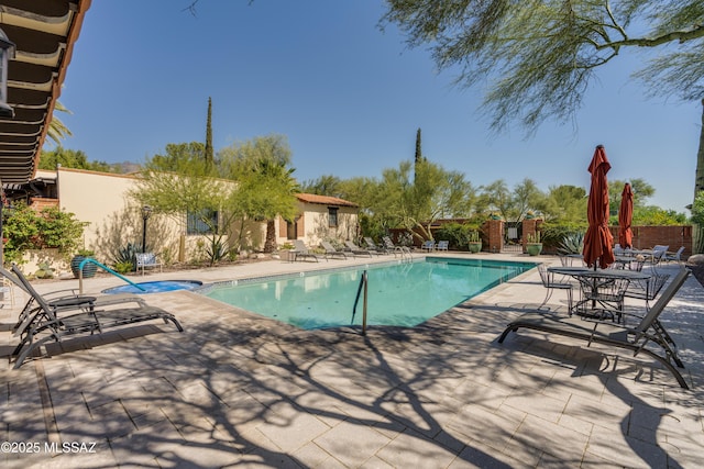 view of swimming pool with a patio