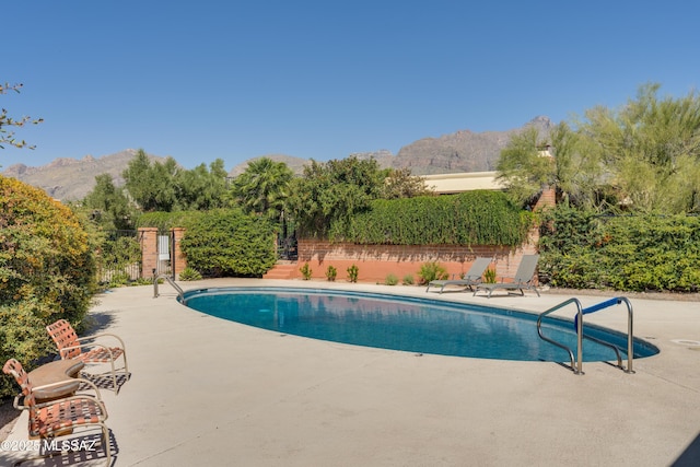 view of pool featuring a mountain view and a patio