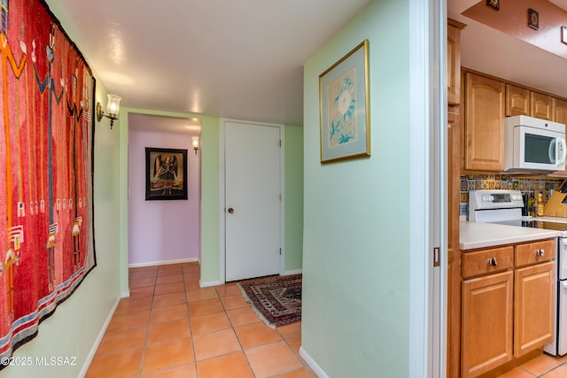 corridor featuring light tile patterned floors