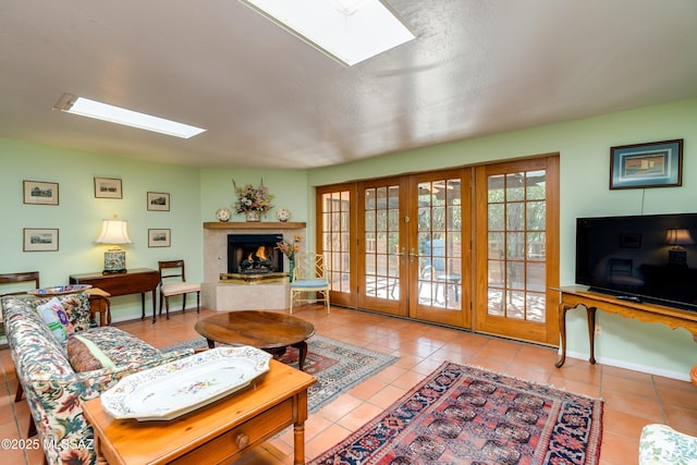 tiled living room featuring french doors and a skylight